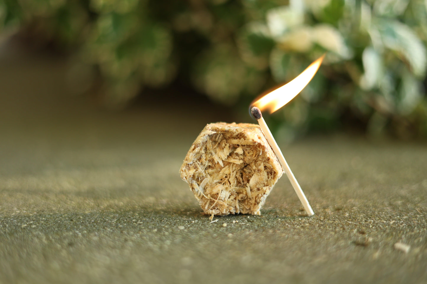 Hexagon beeswax fire starter made from recycled pine shavings and spent grain, perfect for camping or home use, burning for up to 10 minutes