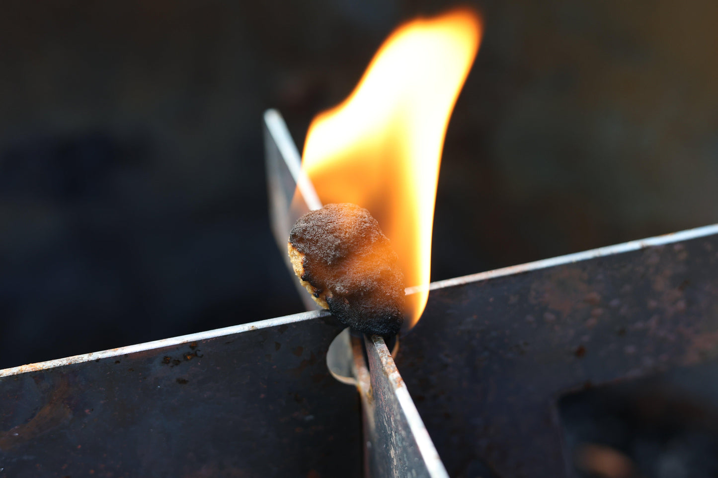 Eco-friendly fire starter shaped like a skull, lighting a fire with just one match for a spooky and efficient start while keeping a mini human skull fire starter design.