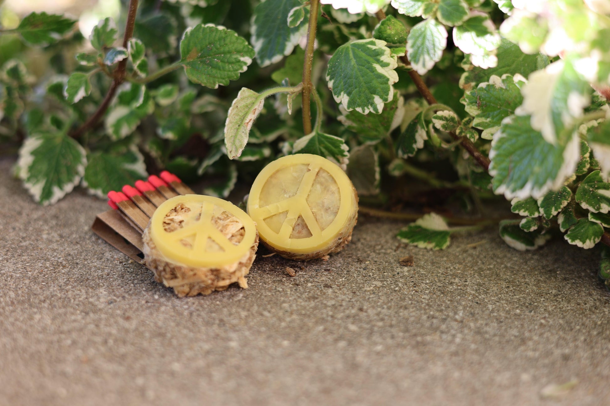 Handcrafted eco-friendly peace sign fire starter made from pine shavings, sawdust, spent grain, and beeswax for sustainable fire-starting