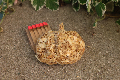 Handmade eco-friendly pumpkin fire starter made with recycled sawdust, pine shavings, and beeswax for an eco-friendly fire-lighting solution