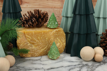 Geometric green Christmas tree fire starter showcasing sustainable materials, including pine shavings, sawdust, and beeswax, ideal for eco-conscious customers.